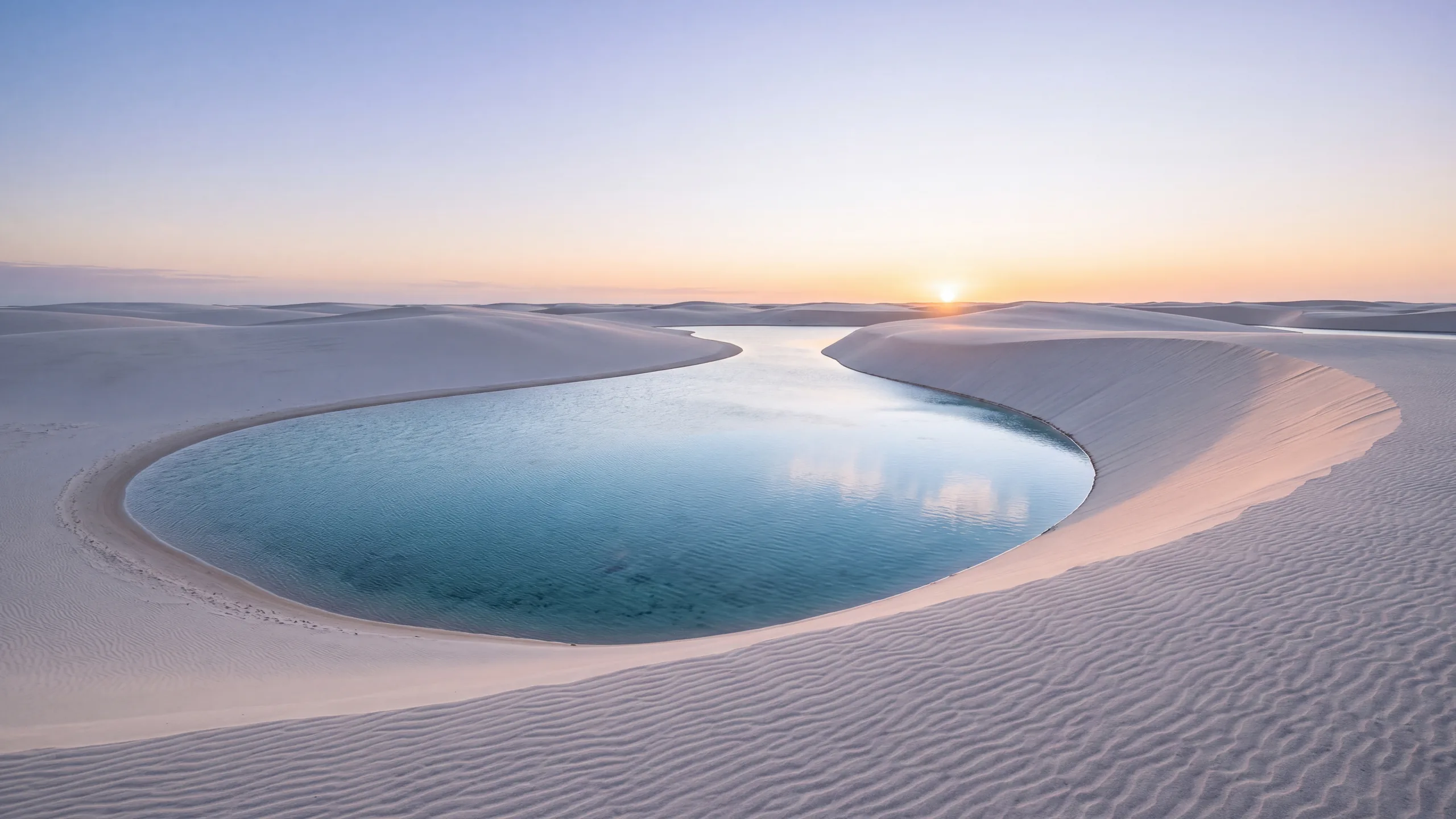 AI-created interpretation of Lençóis Maranhenses in Brazil at sunrise, with white coastal dunes enclosing a clear blue lagoon beneath a pale peach sky.