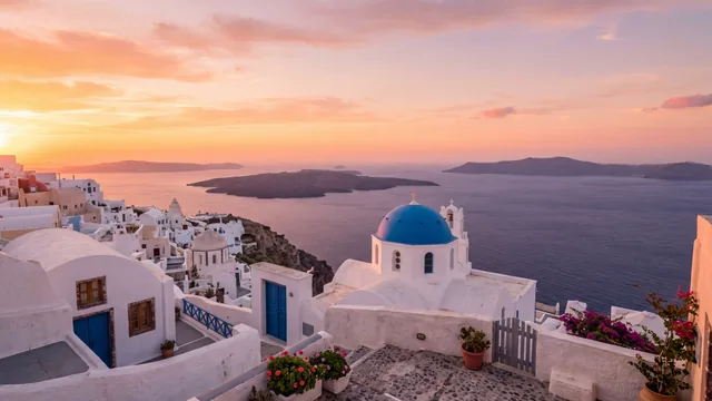 AI-created interpretation of a Santorini sunset with white Cycladic buildings, a blue dome, amber clouds, and the glowing Aegean Sea.